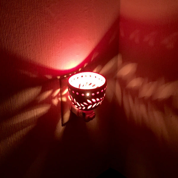 round night light in white with wavey leaf designs and yellow orange interior