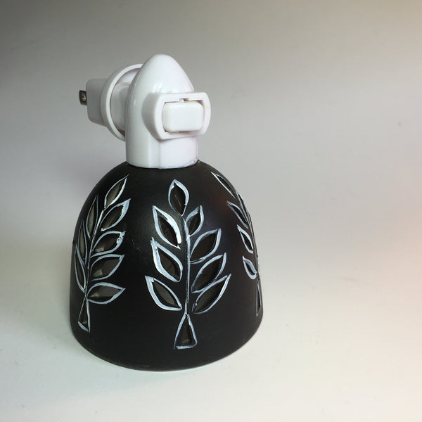 round nightlight with white outlined leaf design